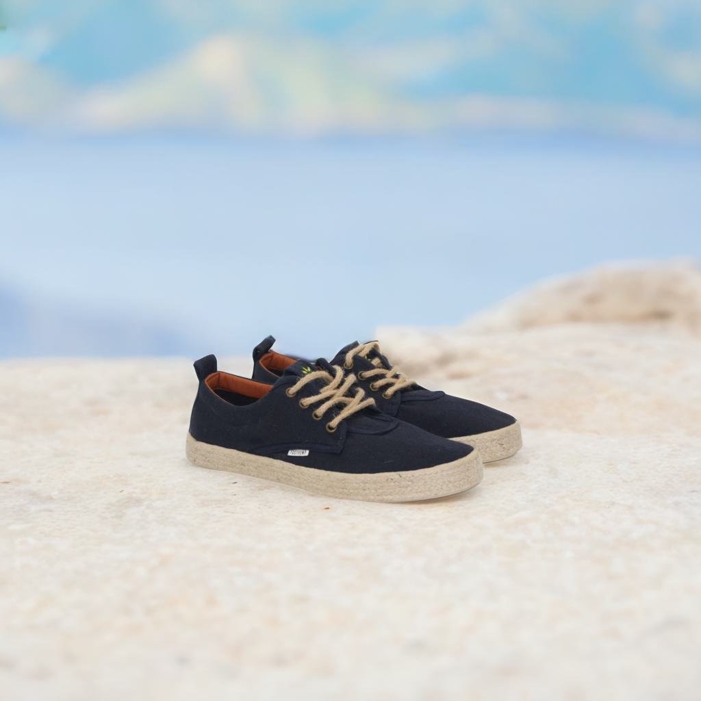 women's hemp shoes on a beach with clouds